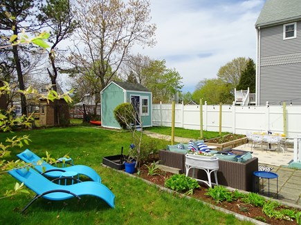 Onset Village MA vacation rental - Back yard with dining area, grill, firepit and seating