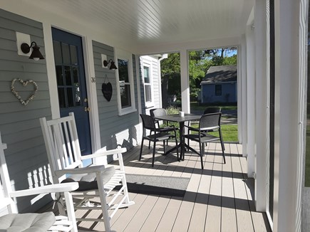 Dennis Port Cape Cod vacation rental - Screened in front porch with rocking chairs and table!
