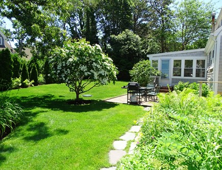 West Harwich Cape Cod vacation rental - Entrance to back yard, patio with grill