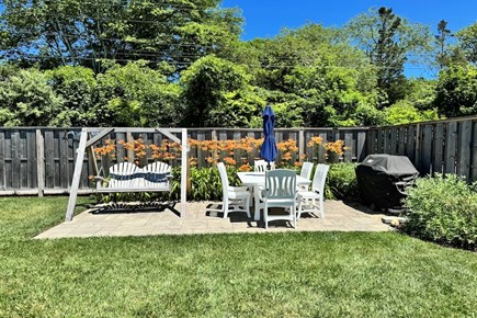 Barnstable Cape Cod vacation rental - Dinining area w/ gas grill and two person swing