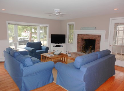 Brewster Cape Cod vacation rental - Living area with TV, leads to porch