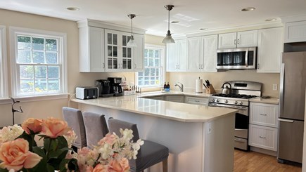 Dennis Cape Cod vacation rental - Inviting white shaker style kitchen with a large island