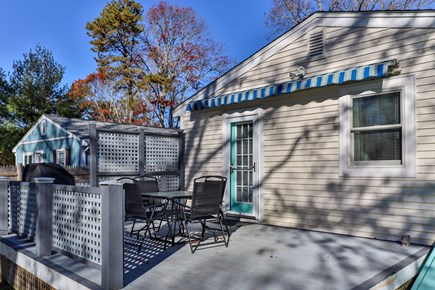 East Falmouth Cape Cod vacation rental - Spacious back deck with patio set, new Weber grill, and awning