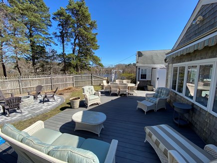 South Yarmouth Cape Cod vacation rental - An expansive outdoor living area with new circular fire-pit