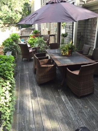 Barnstable Village, MA Cape Cod vacation rental - Separate deck off the kitchen with gas fire table & a gas grill.