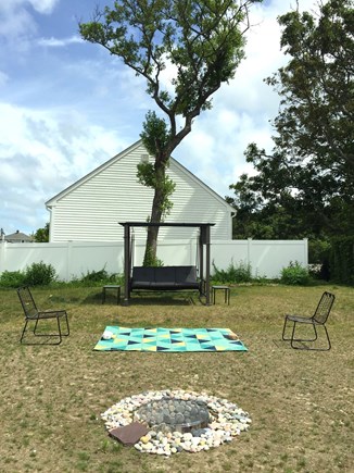 Plymouth, Priscilla Beach MA vacation rental - Large back yard with love seat swing and fire pit.