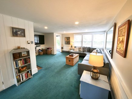 Wellfleet Village Cape Cod vacation rental - Cozy living room with retro-peacock green carpet