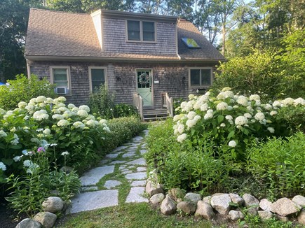 West Falmouth Cape Cod vacation rental - Patio to the left with table and chairs, chaise, sofa, shower