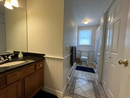 Harwich Cape Cod vacation rental - Hallway bathroom with washer and dryer.