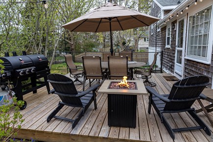 South Yarmouth Cape Cod vacation rental - Deck: fire pit, gas + charcoal grill, seating and canopy lights