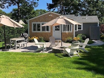 Mashpee, Popponesset Cape Cod vacation rental - Backyard with patio and firepit