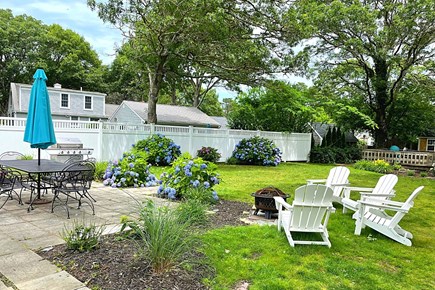South Yarmouth Cape Cod vacation rental - Backyard with Outside Table, Grill, and Fire pit
