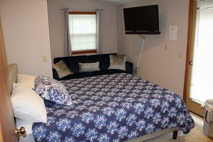 Eastham Cape Cod vacation rental - Main Fl. Queen Bed, sofa, dresser, door to porch. 42 Smart TV