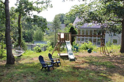 Eastham Cape Cod vacation rental - Lower level yard w/hammock, chairs and swing set