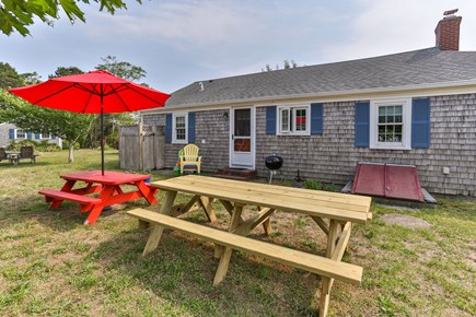 Truro Cape Cod vacation rental - Back - red table no longer there but umbrella remains.