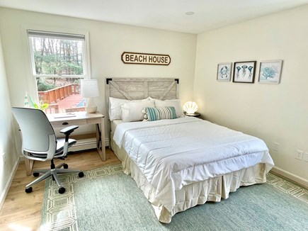 Harwich Cape Cod vacation rental - This bedroom features a queen bed and desk overlooking the pool
