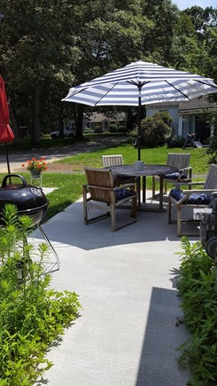 Osterville, Close to Town Centre Cape Cod vacation rental - Patio with charcoal grill surrounded by beautiful flowers/bushes