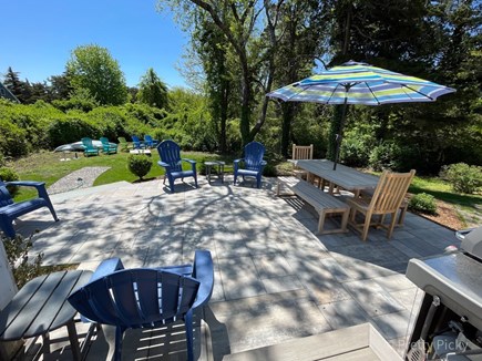 East Orleans Cape Cod vacation rental - Patio overlooks larger section of yard leading to the food burning firepit.