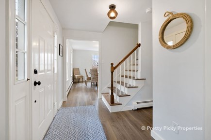 East Orleans Cape Cod vacation rental - Hallway and staircase leading to the second floor.