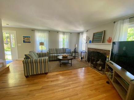 Orleans Cape Cod vacation rental - New coastal and striped love seat with new jute rug.
