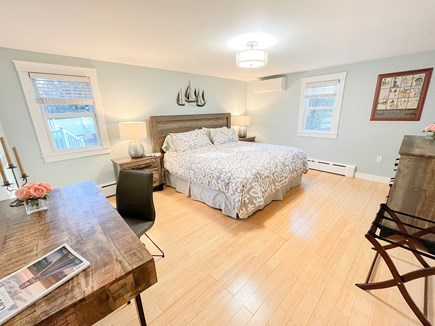Centerville, Town of Barnstable Cape Cod vacation rental - First floor main bedroom with a king size bed, dresser, and desk.