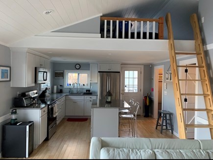 Sandwich, Forestdale Cape Cod vacation rental - View of the kitchen, entry way, and sleep loft ladder.