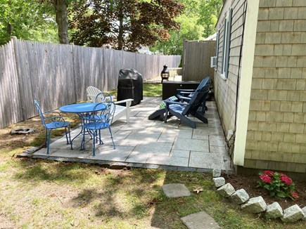 South Yarmouth Cape Cod vacation rental - Patio with outdoor dining table, sitting area and gas grill.