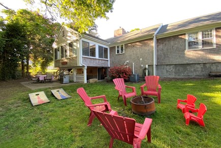 Yarmouth Cape Cod vacation rental - Fenced Back Yard with Fire Pit, Grill, & 2 Dining Table Sets