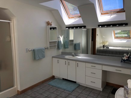 East Harwich Cape Cod vacation rental - Primary bathroom-vaulted ceiling, skylights, shower & soaking tub