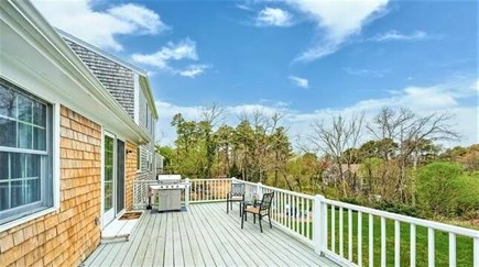 Brewster Cape Cod vacation rental - Back deck over large back yard - grill and outdoor dining