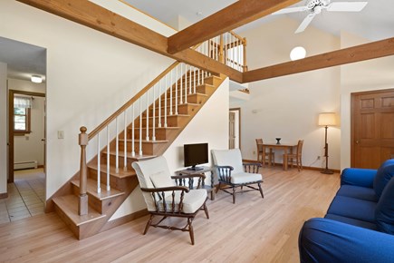 Eastham, Sunset House Cape Cod vacation rental - Living room and stairs leading to the second floor