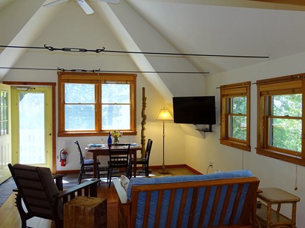 Provincetown Cape Cod vacation rental - Living area with TV, dining table, facing South