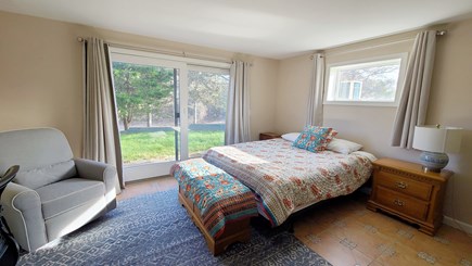 Truro Cape Cod vacation rental - Lower level bedroom with queen bed and slider to backyard