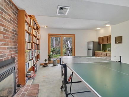 West Falmouth Cape Cod vacation rental - First-floor game room with ping pong, books, games, and wet bar!