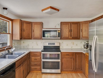 West Falmouth Cape Cod vacation rental - Kitchen with dishwasher, refrigerator, microwave, and oven.