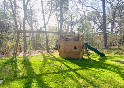 North Falmouth Cape Cod vacation rental - Large grassy play area with play structure with swings.