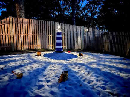 West Yarmouth Cape Cod vacation rental - Backyard sand beach/kids corner with lighthouse and sand toys
