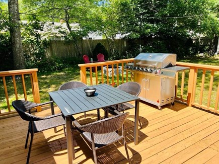 Hyannis Cape Cod vacation rental - Backyard deck with grill , tables and chairs