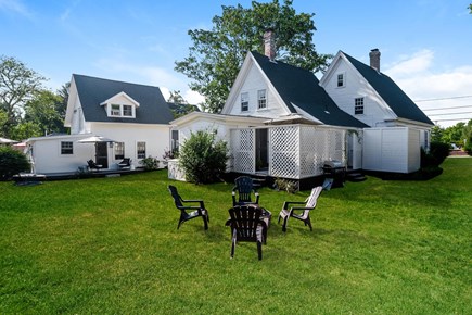Dennisport Cape Cod vacation rental - Backyard with seating and plenty of room for lawn games