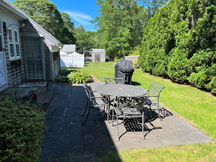 South Yarmouth Cape Cod vacation rental - Spacious fenced backyard with patio and grill.