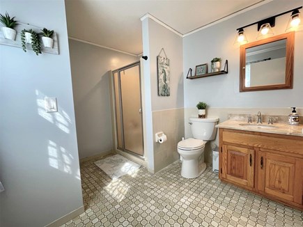 Centerville Cape Cod vacation rental - Master bathroom with a shower with a seat and grab bars.