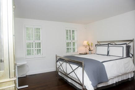 Dennis Village Cape Cod vacation rental - Primary Bedroom has Queen Sized Bed & Flat Screen TV in cabinet.