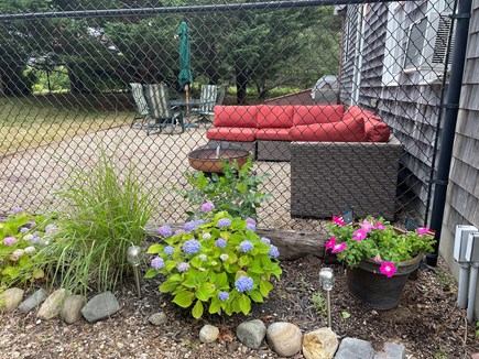 North Truro Cape Cod vacation rental - Fenced backyard with fire pit, grill, hammock & outdoor shower.