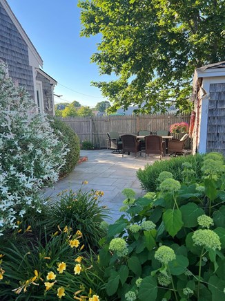 Dennisport Cape Cod vacation rental - Peaceful Side patio plenty of seating with chairs, rockers.