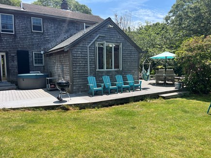 Eastham Cape Cod vacation rental - Backyard, hot tub, plenty of chairs and weber charcoal grill