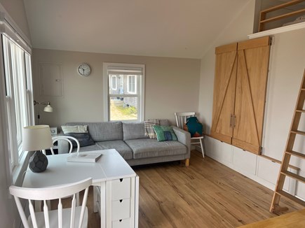Truro Cape Cod vacation rental - Living room with barn doors to queen bedroom