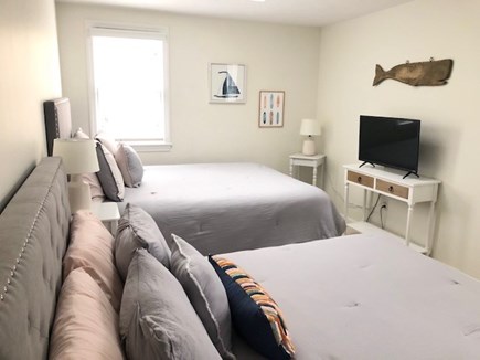 Harwich Cape Cod vacation rental - Upstairs bedroom with queen beds, skylight, and smart TV