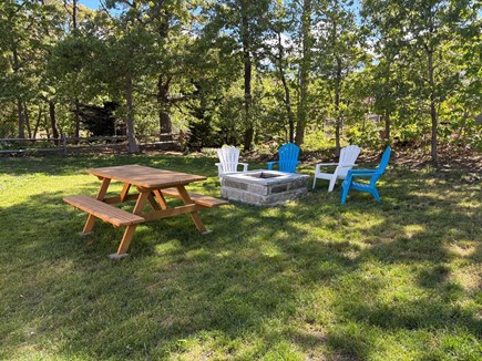 Eastham Cape Cod vacation rental - Granite fire pit area with chairs and b.b.q. grill