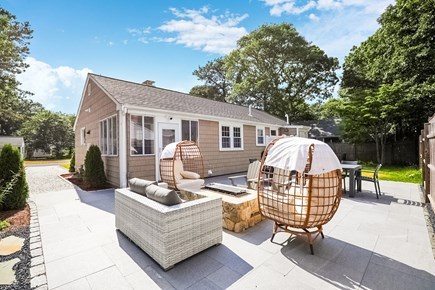 Yarmouth Cape Cod vacation rental - Outdoor sitting area with egg chairs, sofa, and Adirondack chairs