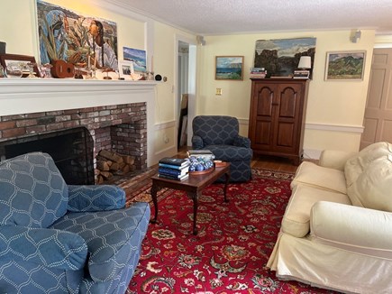 Barnstable Village Cape Cod vacation rental - Sunny living room w/fireplace- also has large dining table.